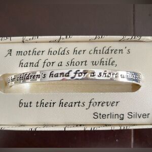 Sterling silver bangle with saying brand new. It’s never been worn.